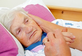 Compassionate hospice assistance in Bethlehem, PA, showing a caregiver gently holding a senior client's hand to provide comfort and emotional support